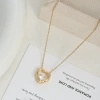 A large heart-shaped pendant with a hollow texture and a small heart embedded inside has a golden texture and a romantic atmosphere details Picture